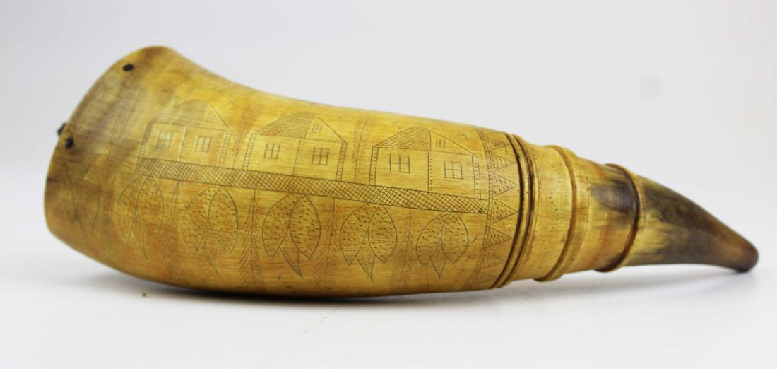 Scrimshaw powder horn: American carved scrimshaw 9" long powder horn. Four rings, houses, foliage, geese, in a overall design. White pine inset with square nails and old ring.