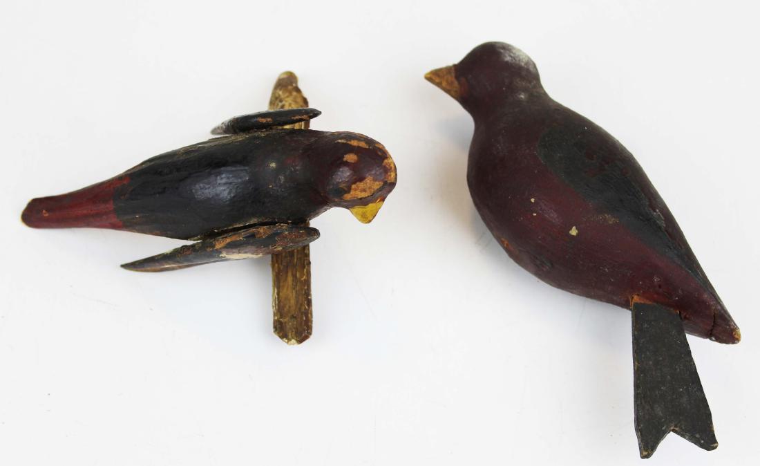 Two late 19th c folk art song bird: Two late 19th c paint decorated folk art song birds. One red, yellow, brown, & black on painted limb with wire legs and wings that partially spin 6" long, second a red, yellow, and dark brown song bir