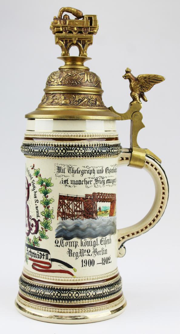 German regimental stein with train finial: ca 1900 German regimental stein with train finial, German Reservist Schmidt II, Kaiser Wilhelm II logo & embossed image on lid, Berlin Telegraph 1900- 1902, ht 11"