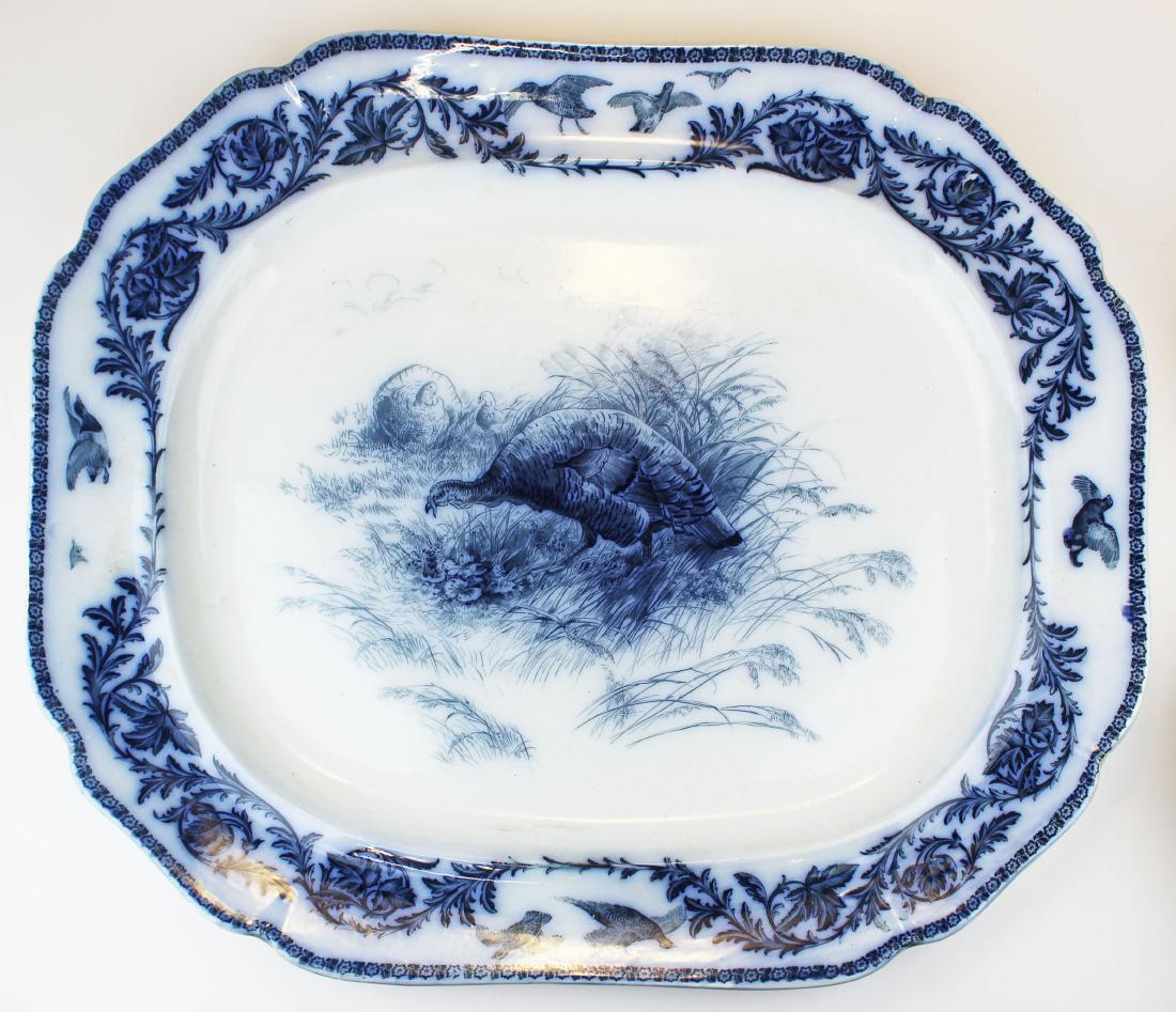 Royal Cauldon flow blue porcelain turkey platter: late 19th c. Royal Cauldon flow blue porcelain platter with transfer decorated center panel of grazing turkeys surrounded by foliate border with gamebirds in flight 21.25" x 25"