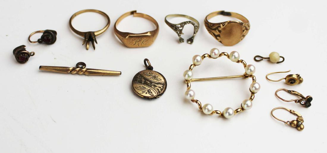 A group of various gold jewelry: A group of various gold jewelry including a 14k circle pin with pearls, 4 gold rings, odd Victorian earrings. 15 grams total weight.