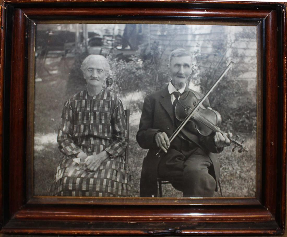 early 20th c photograph of couple: early 20th c photograph of couple, man holding violin, originally backed with 1934 South bend, Indiana newspaper (preserved), 10 1/2" x 13 1/2"
