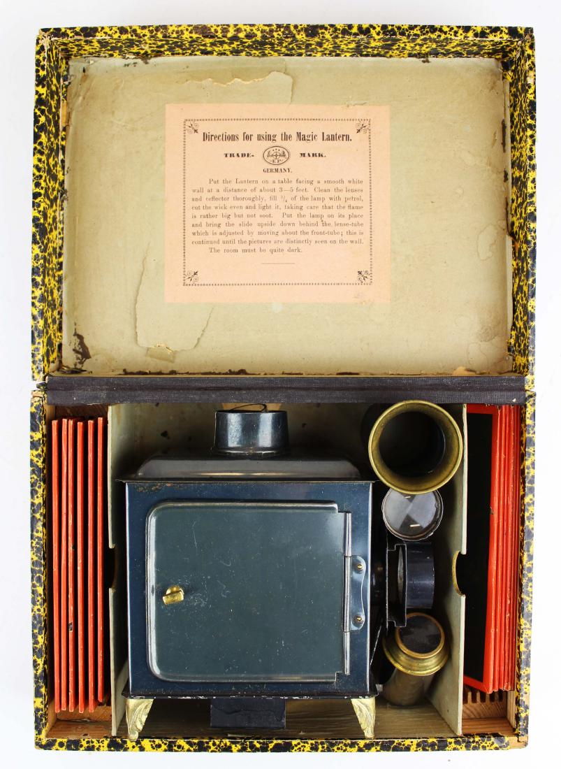 Magic Lantern with slides in original wooden case: Magic Lantern with 12 slides in original papered wooden case, label, box hinge intact, dent through top of case, 10" x 7 1/4" x 3 1/2"