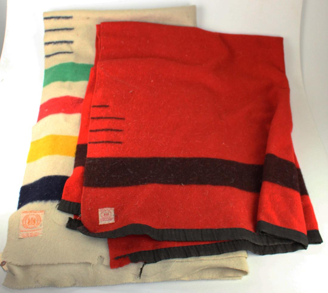 Two Hudson Bay company blankets: Two Hudson Bay "Point Blankets" white four point blanket, and red three and a half point blanket. Used condition with repairs. Red blanket rebound edges, minor tears on white blanket.