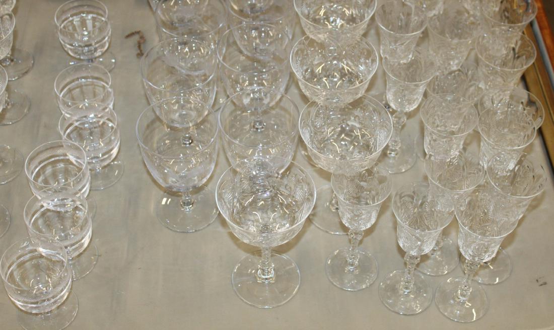 53 pcs. Elegant depression era wheel cut stemware: 53 pcs. Elegant depression era wheel cut stemware, including a large set of elaborately cut goblets, Cambridge style wine goblets with etched pine cone pattern, etc.