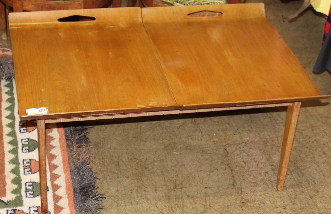 Modern double tray top low table: Danish modern teak low table with two bent laminate removable tray tops. Cloth woven under supports. 38" x 25" x 18".