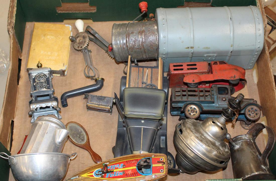 Lot of toys: Lot of metal toys including Felix Sea Cat tin litho boat, Two Hubley cast iron trucks, Banks, Tops, Etc