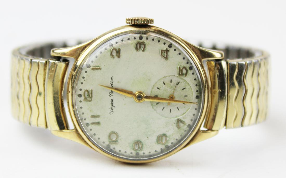 Ulysse Nardin men's gold wrist watch: Ulysee Nardin 10 k yellow gold mid 20th c round men's wrist watch. Arabic numerals, second hand dial, 30 mm diameter. 10k g.f. elastic metal wrist band. Running monogramed back.