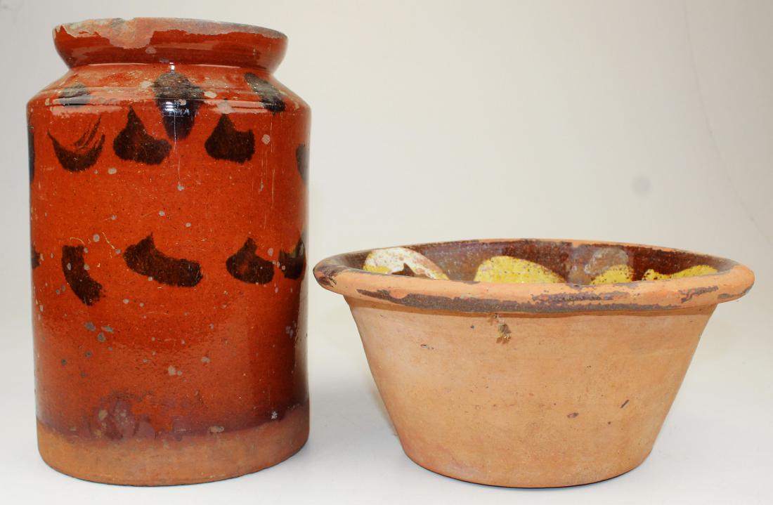 redware covered jar & open bowl: redware covered jar with manganese glaze, slip decorated redware bowl (both with glaze flaking, losses), hts 10 1/2", 5", bowl diameter 10"