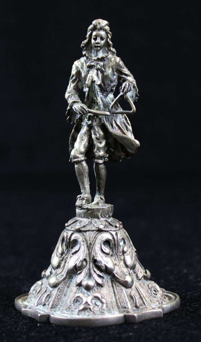 Continental cast 800 silver figural dinner bell: Continental cast 800 silver dinner bell with baroque style scroll flourishes in relief, surmounted by a figural handle of gentleman playing a cymbal 4.75" x 2.5" 7.7 troy oz.