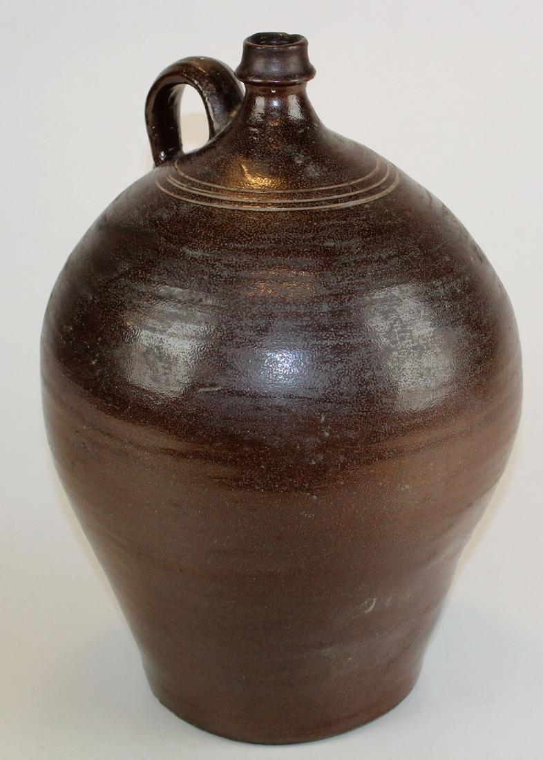 Single Handle Probably South Carolina Redware Jug: Single handled redware jug, Probably from South Carolina, three rings around top, through handle. Ht 16"