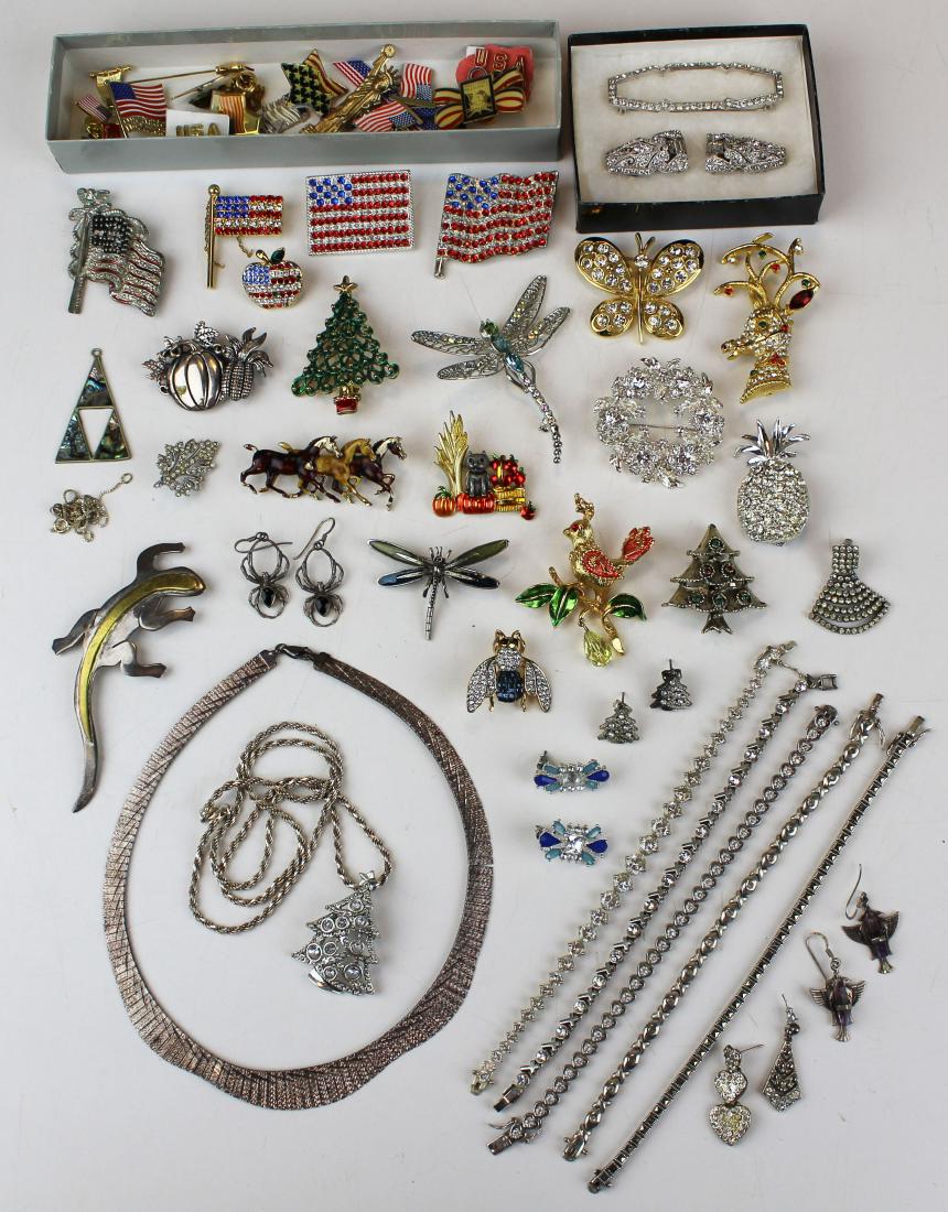Sterling, figure, & rhinestone jewelry: A group of jewelry items including vintage figural Christmas pins, dragon flies, flags, bug, ca. 1950 rhinestone clips, necklaces, and sterling pins, necklaces, and earrings.