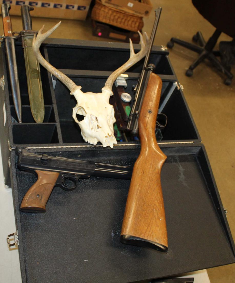 Outdoor lot: Two WWII Era bayonets, Whitetail skull, Daisy air pistol, Crossman C02 rifle, Compasses, Shooter's Range box
