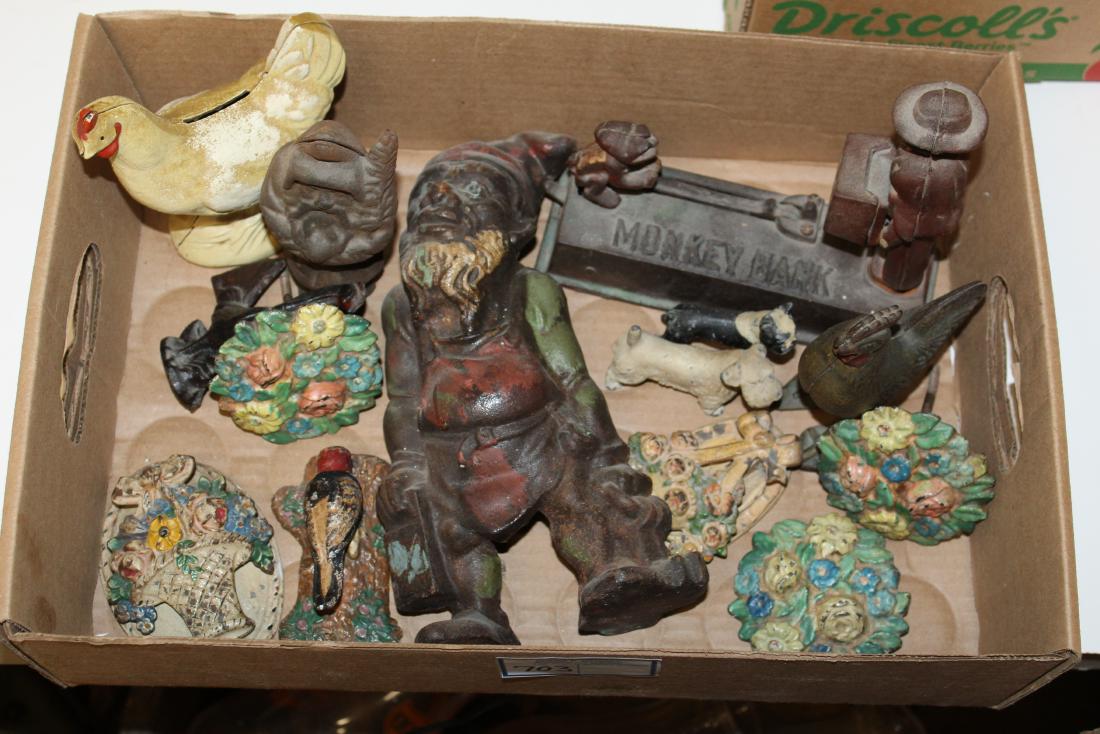 20th c cast iron banks, decorative items: 20th c cast iron banks, decorative items including early 20th c door knockers, curtain tie backs, old rooster still bank, late 20th c banks, troll figure, hts/ lengths 3" to 10"