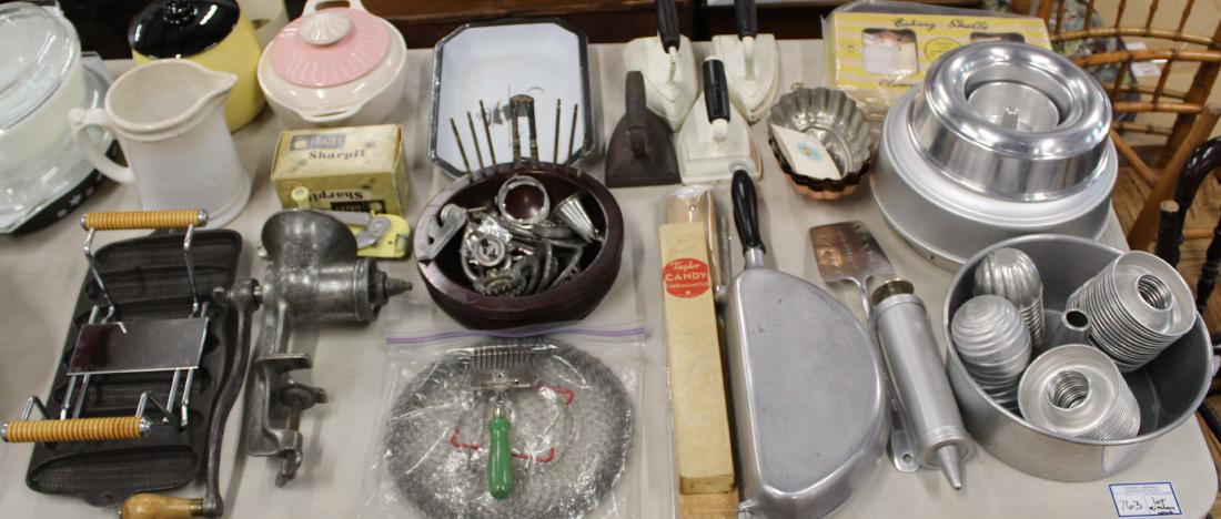 large lot of vintage kitchen accessories: large lot of vintage kitchen accessories including enameled cast iron pan, Wagner Ware Krusty Korn pan, 2 cookie jars, 4 flat iron doorstops, herb mincer, cookie press, aluminum pans, etc., all in exc