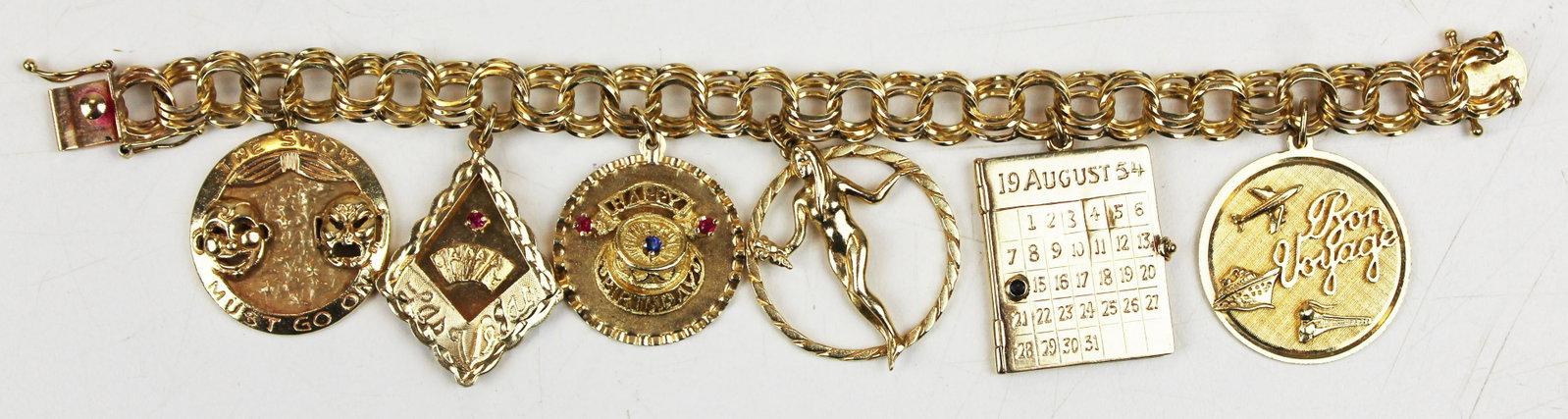 14k yellow gold charm bracelet: 14k yellow gold charm bracelet with 6 large charms, & chain all marked 14k. 59.2 grams t.w.