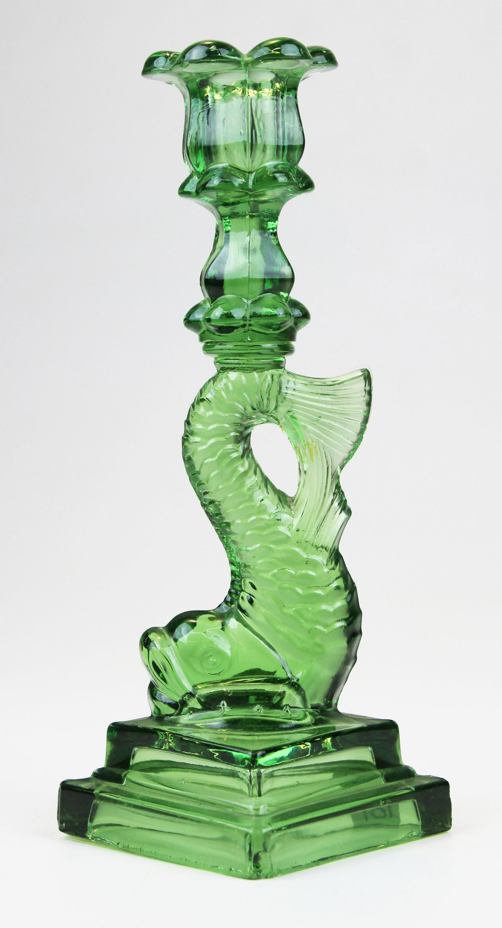 pressed glass dolphin base candlestick: early glass dolphin base candlestick, double step, very unusual color of light green, beveled bottom, ht 10"