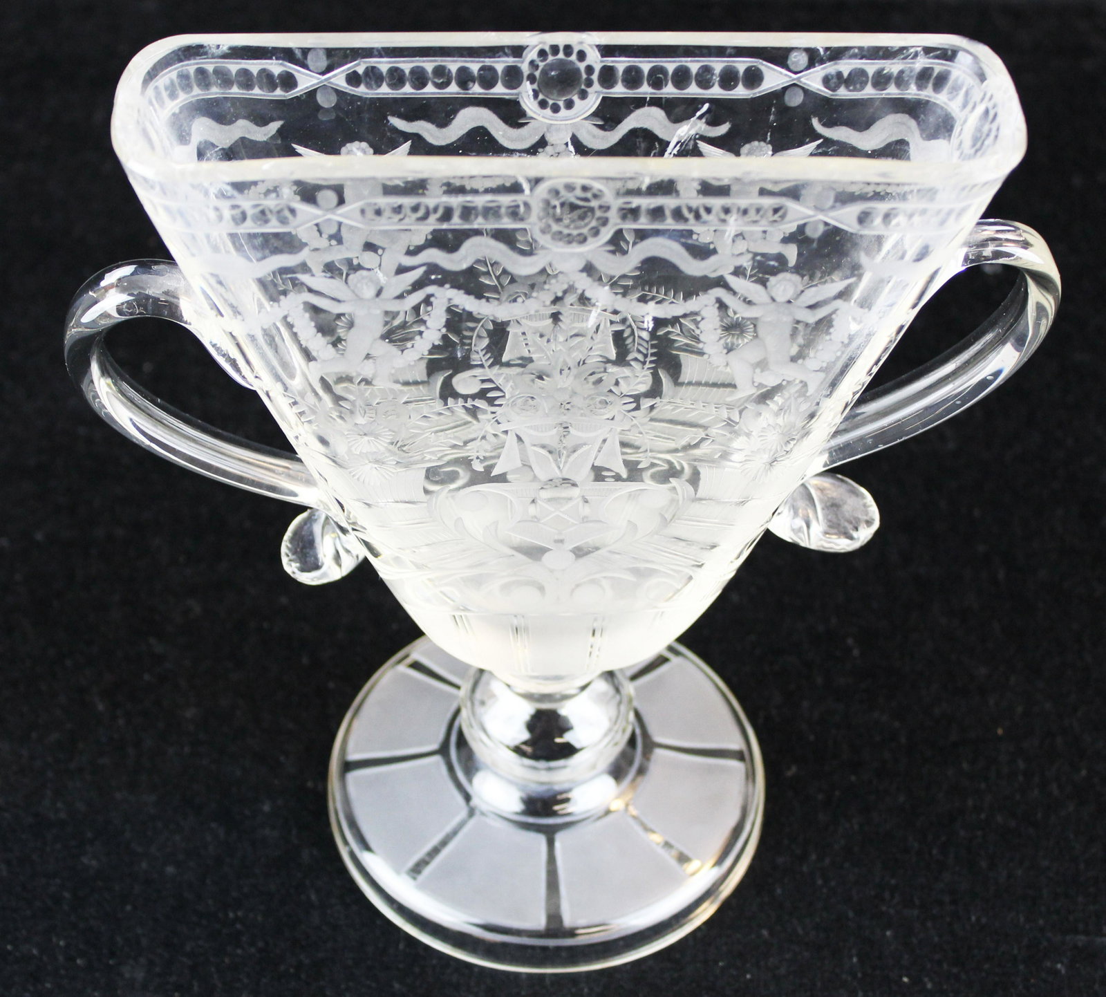 Stiegel type engraved pinched footed vase: Stiegel type engraved pinched footed vase with handles, small chips on rim, ht 8 3/4"