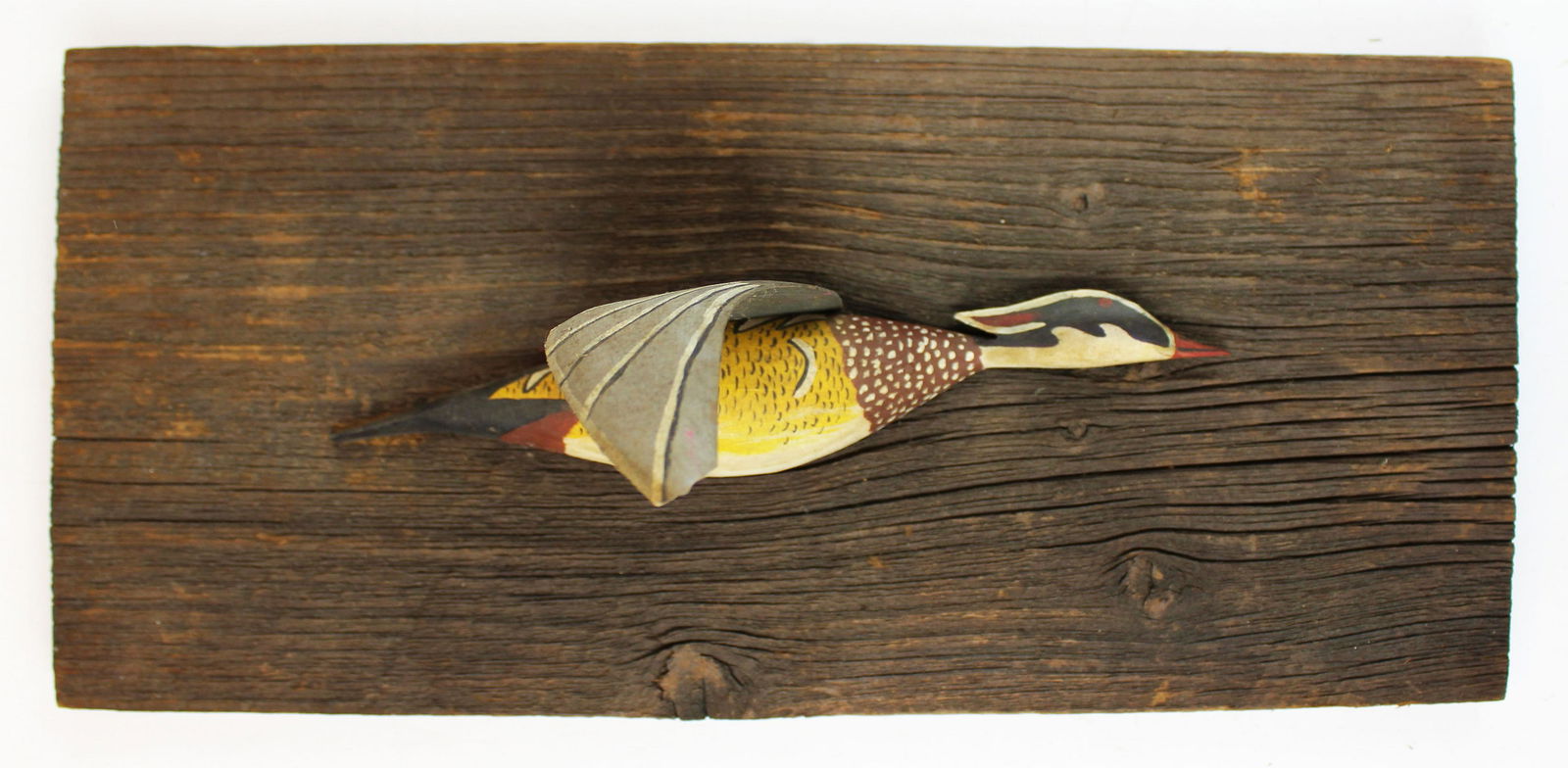 wood duck relief carved by Larry Scanlon: wood duck carved in relief by Larry Scanlon (VT- contemporary), mounted on barn board, small chip on tip of wing, overall length 14"
