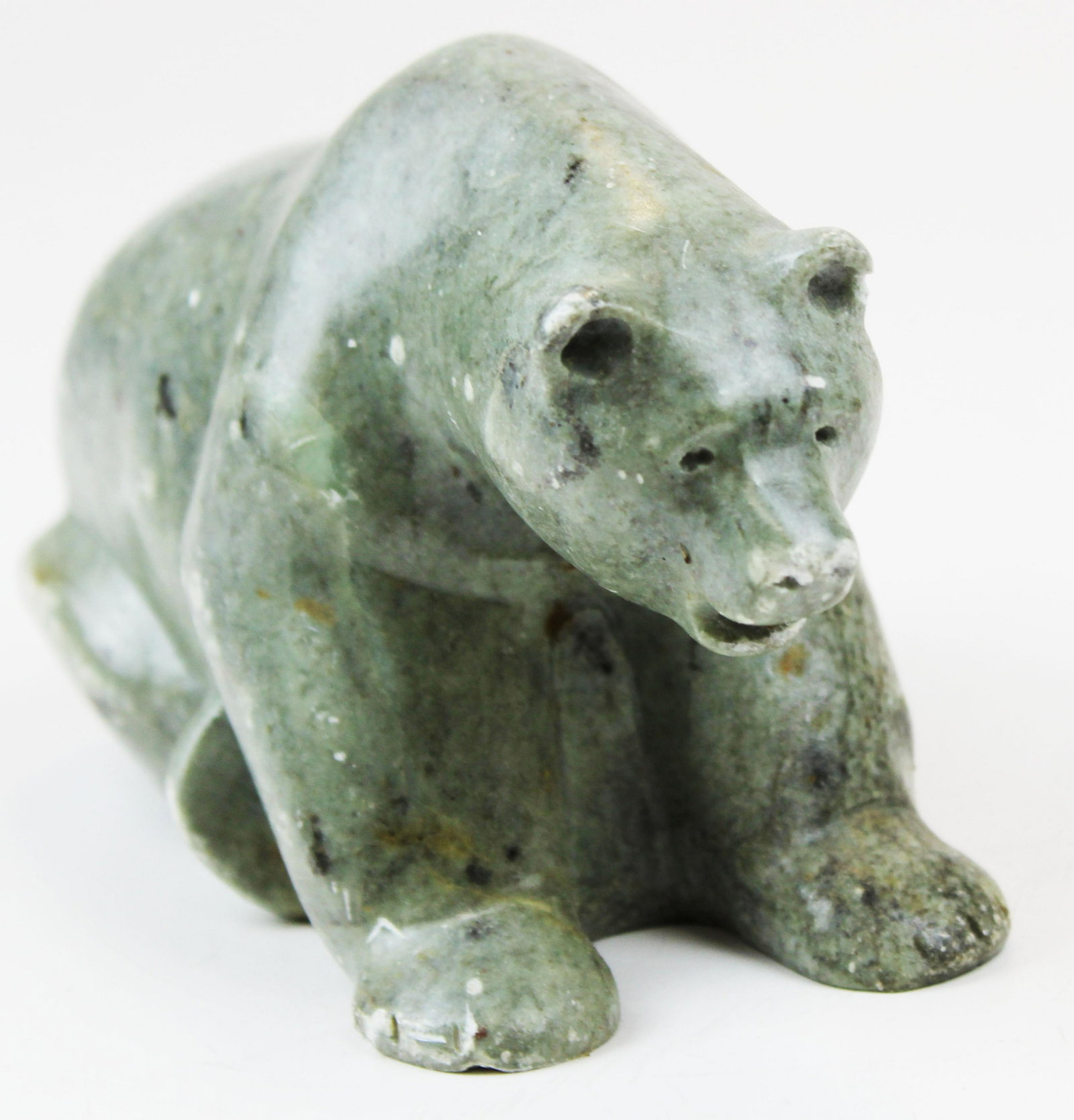 mid 20th c Inuit stone carving of a bear: mid 20th century Inuit stone carving of a bear, wire in mouth, probably had a fish, length 7"