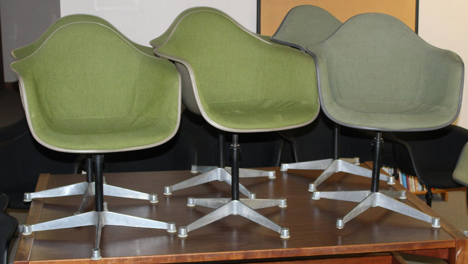 Set of 6 Green Herman Miller Shell Chairs: Charles and Ray Eames designed Herman Miller "La Fonda" mid-century industrial shell chairs in Green upholstery with Feb 11 1970 date stamps on most. These are bulky items and will need to be picked u