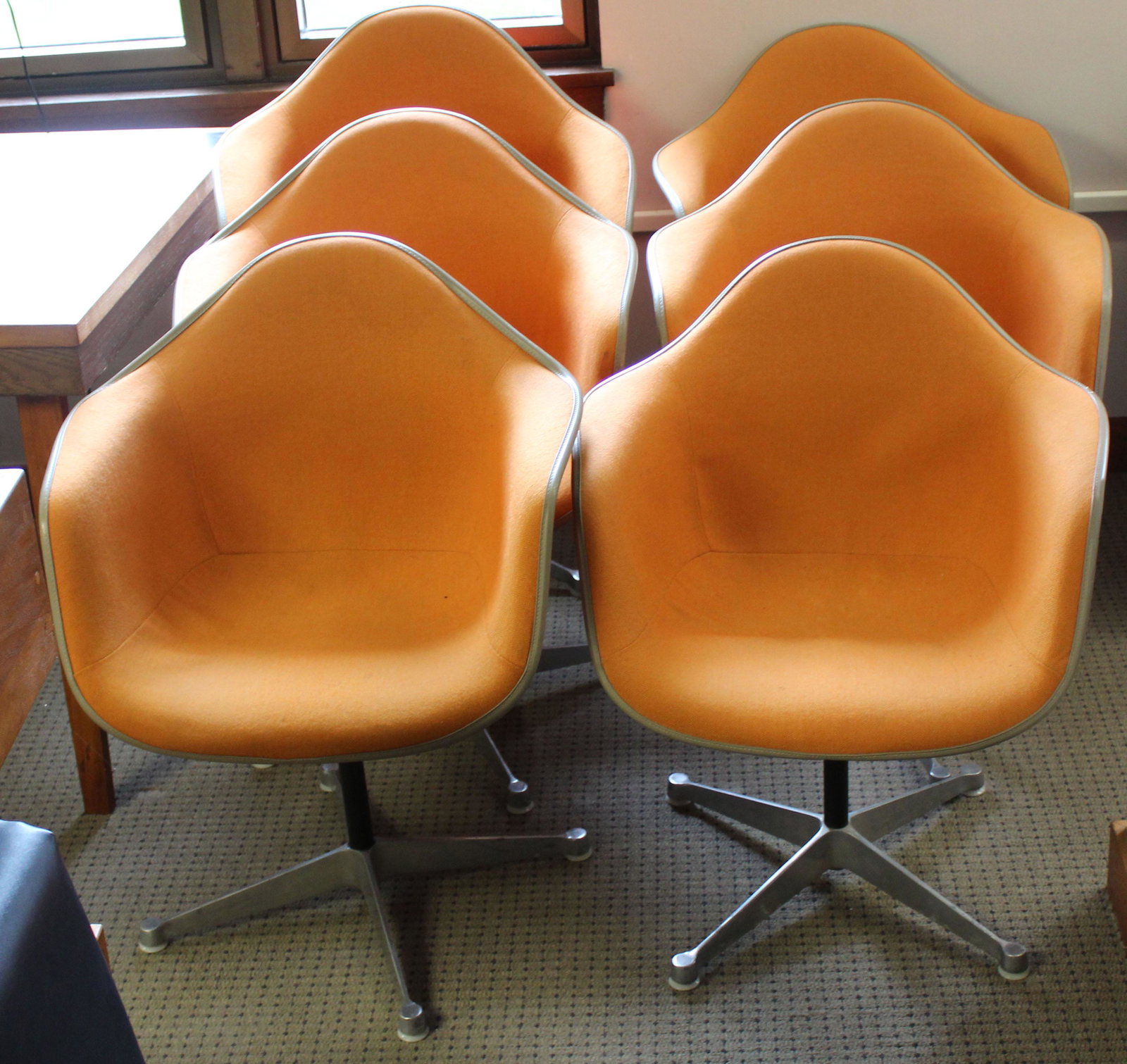 Set of 6 Orange Herman Miller Shell Chairs: Charles and Ray Eames designed "La Fonda" Herman Miller mid-century industrial shell chairs in Orange upholstery with Feb 11 1970 delivery stickers on most