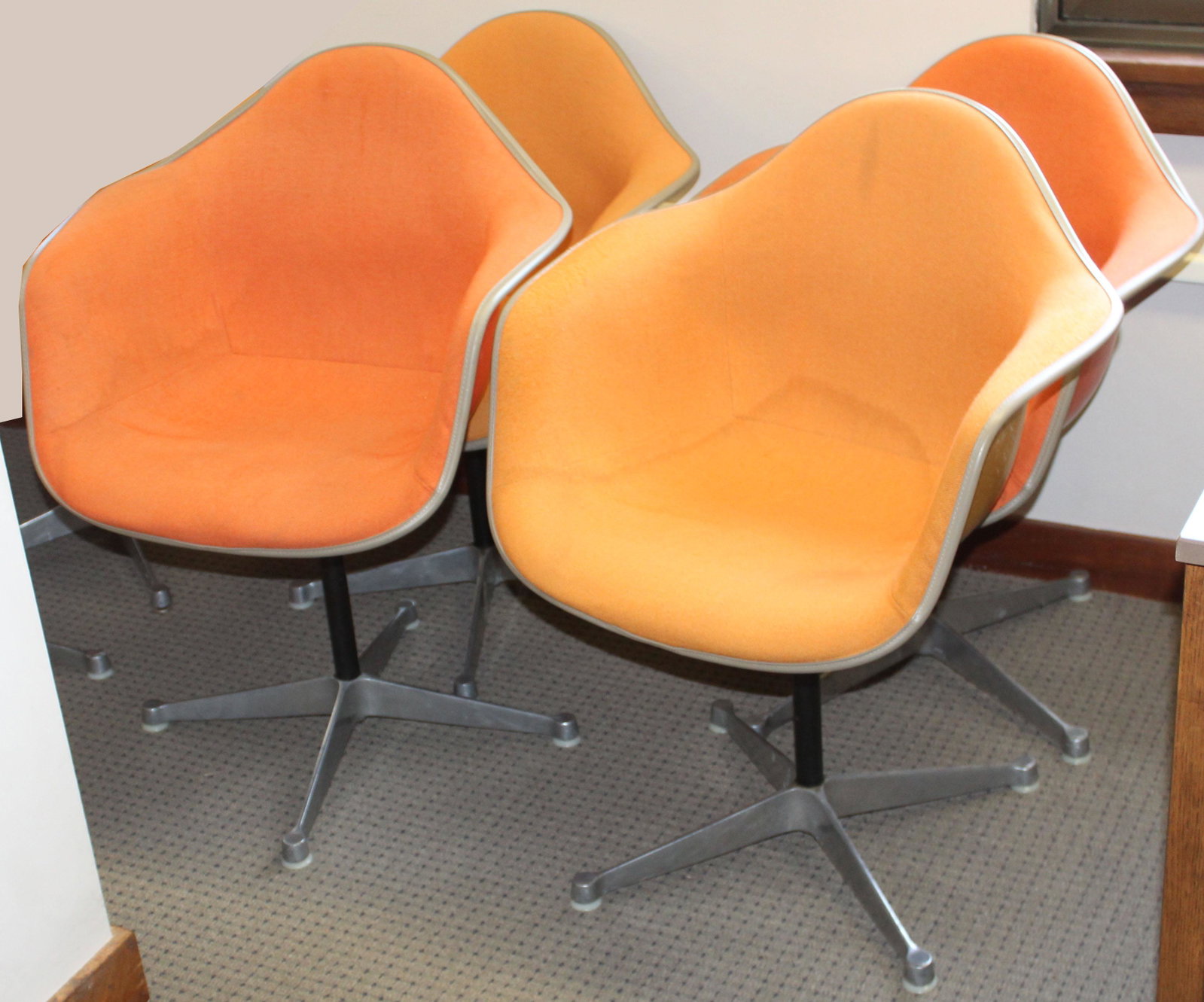 Four Orange Herman Miller Shell Chairs: Charles and Ray Eames designed Herman Miller "La Fonda" mid-century industrial shell chairs dated Feb 1970 most marked with GMC LIB underneath