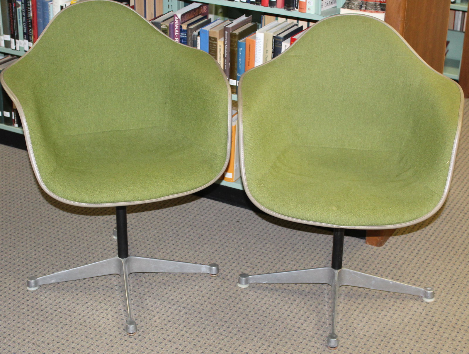 Pair of Green Herman Miller Chairs: Pair of Charles and Ray Eames designed Herman Miller "La Fonda" mid- century industrial shell chairs in green upholstery