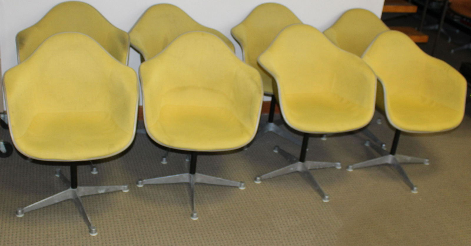 Eight Gold Herman Miller Chairs: Eight Charles and Ray Eames designed Herman Miller "La Fonda" mid- century industrial shell chairs in gold upholstery most marked Feb 1970 some with GMC LIB etched on shelll