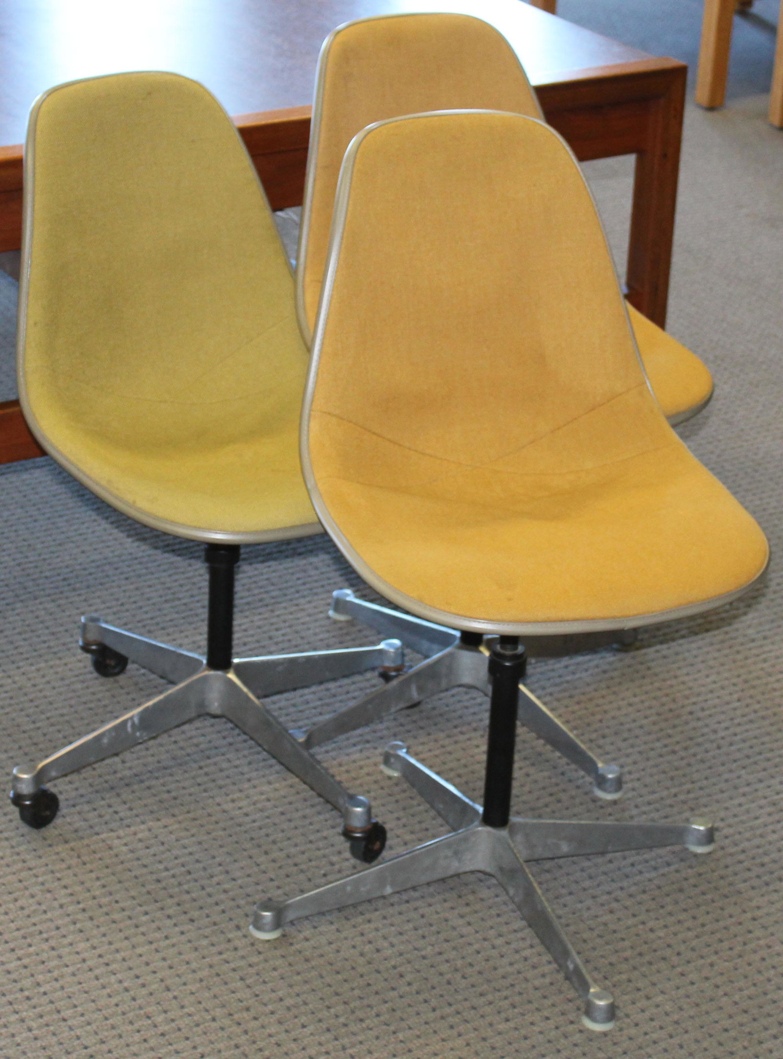 Three Herman Miller shell chairs: three Charles and Ray Eames designed Herman Miller side chairs