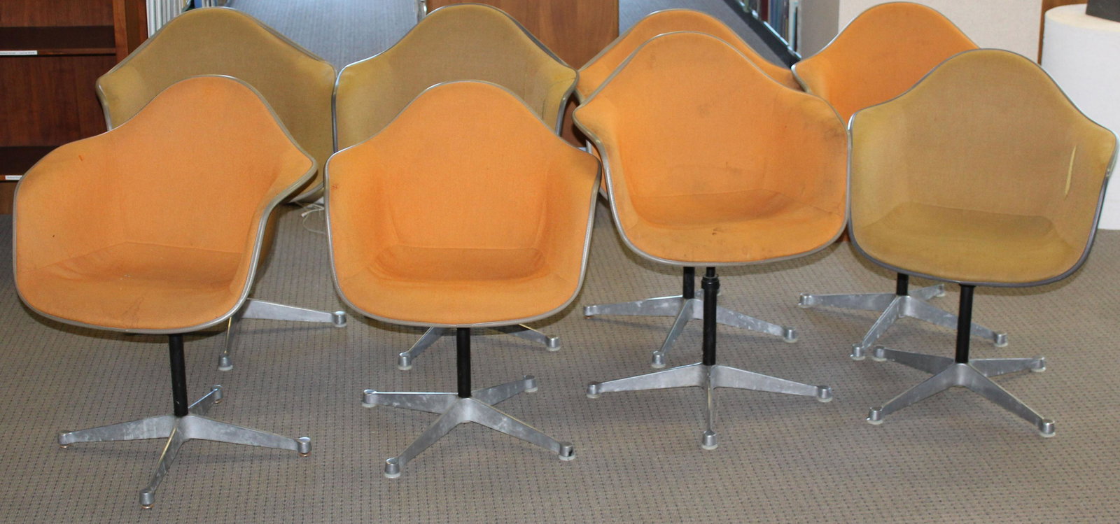 Eight Herman Miller Shell Chairs: Eight Charles and Ray Eames designed Herman Miller "La Fonda" mid- century industrial shell chairs in assorted upholstery most marked Feb 1970 some with GMC LIB etched on shelll