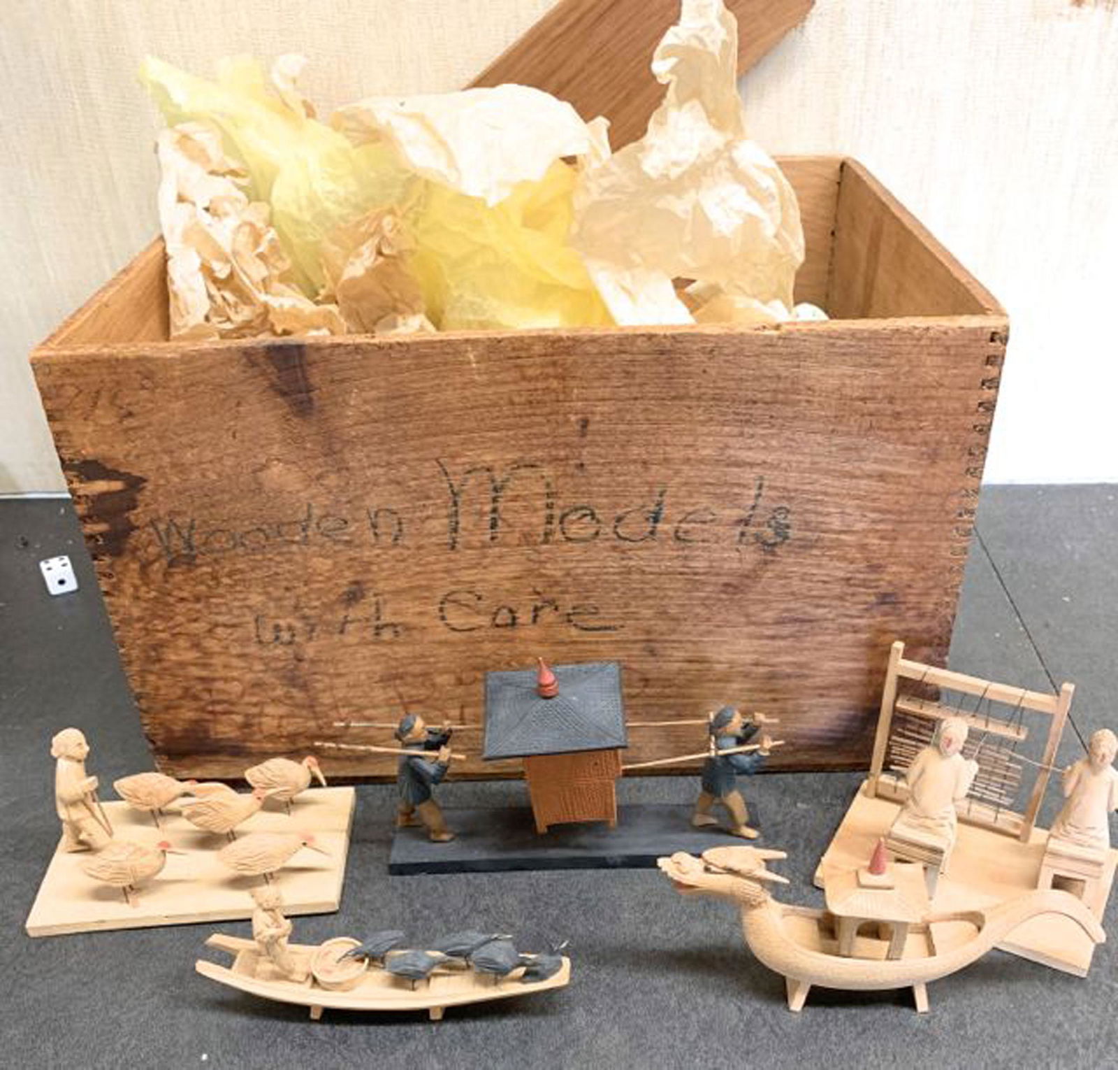 A group of Chinese miniature models: A group of early 20th c carved wooden miniature models of daily life, dragons, boats. Approximately 20 pcs.