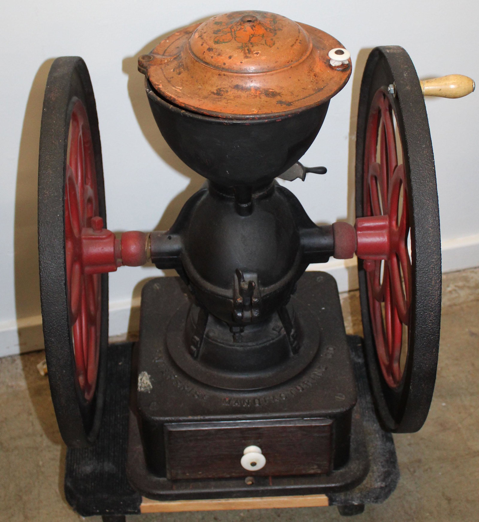 large Enterprise cast iron coffee grinder: large Enterprise cast iron coffee grinder, break to upper body at lid attachment, later paint, wheel diameter 18", height 26" (local pick-up/ private carrier strongly recommended)