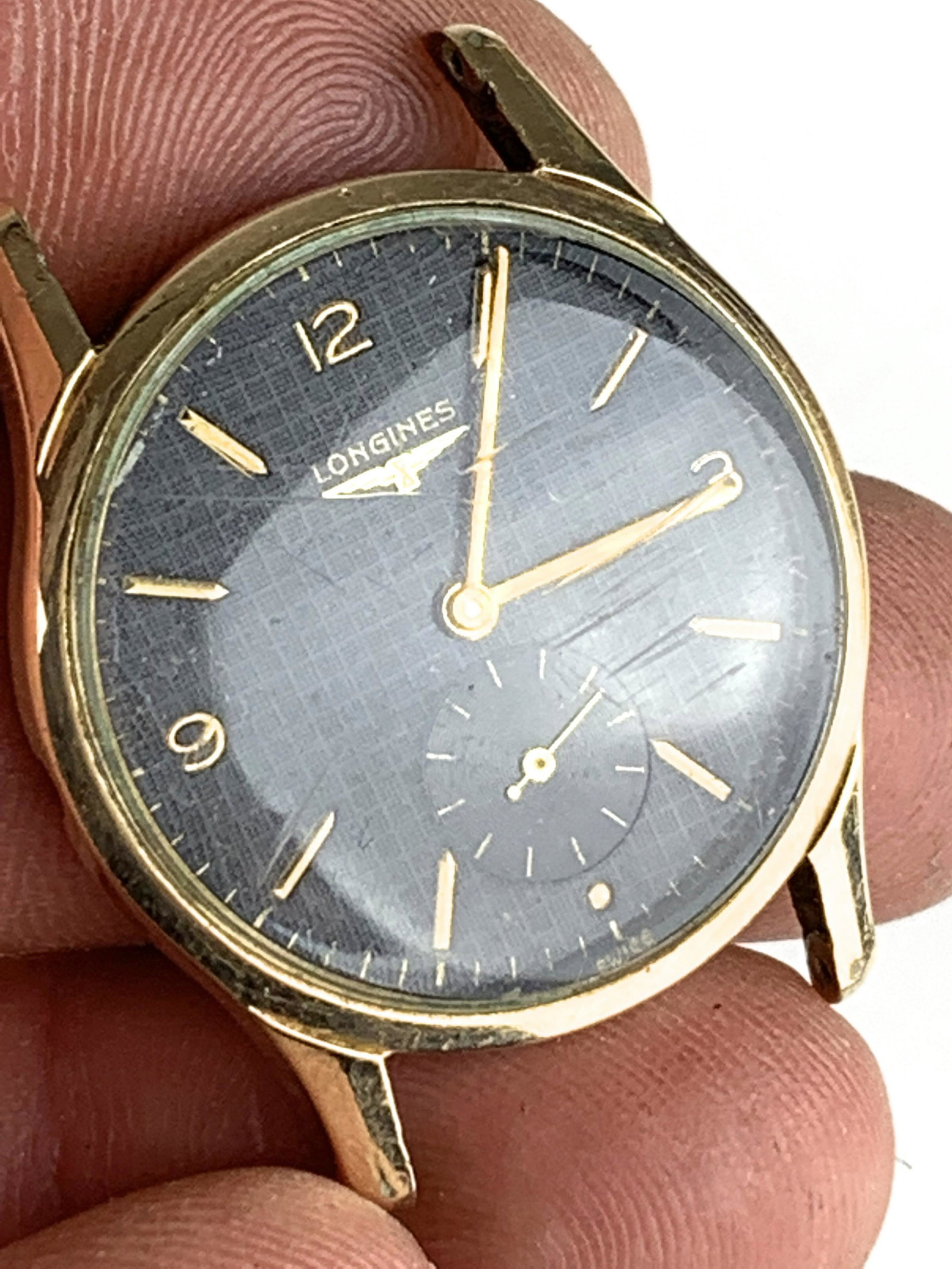 Longines men's wrist watch: 10k gold filled Longines men's wrist watch. Black dial with gold hands. Not running, as is.