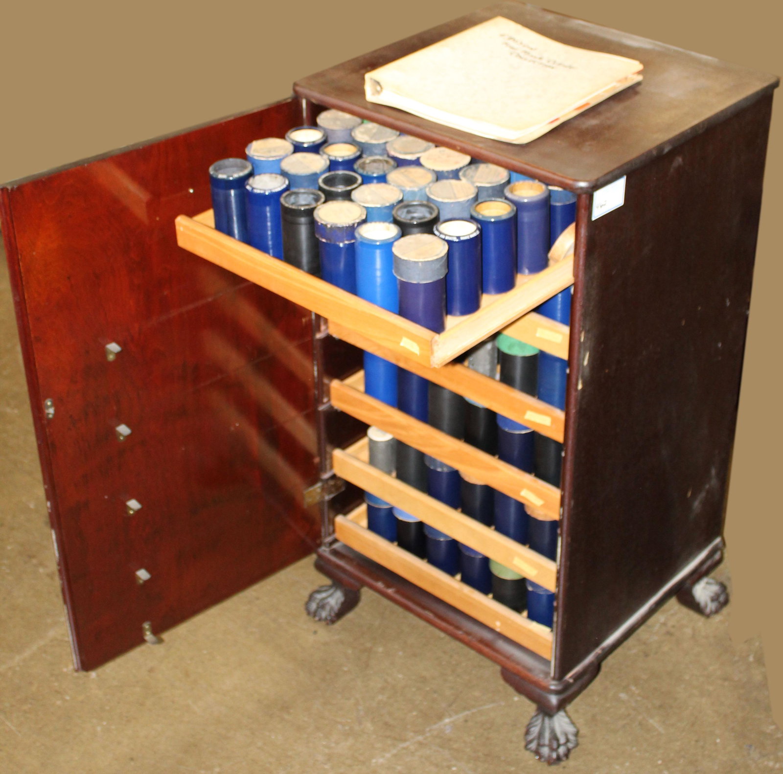 Mahogany cylinder record cabinet and 216 records: excellent mahogany 1 door cylinder record cabinet on finely carved claw feet, having 6 sliding birch shelves holding 216 Edison 4 minute cylinder records, including blue and black Amberol, all fully c