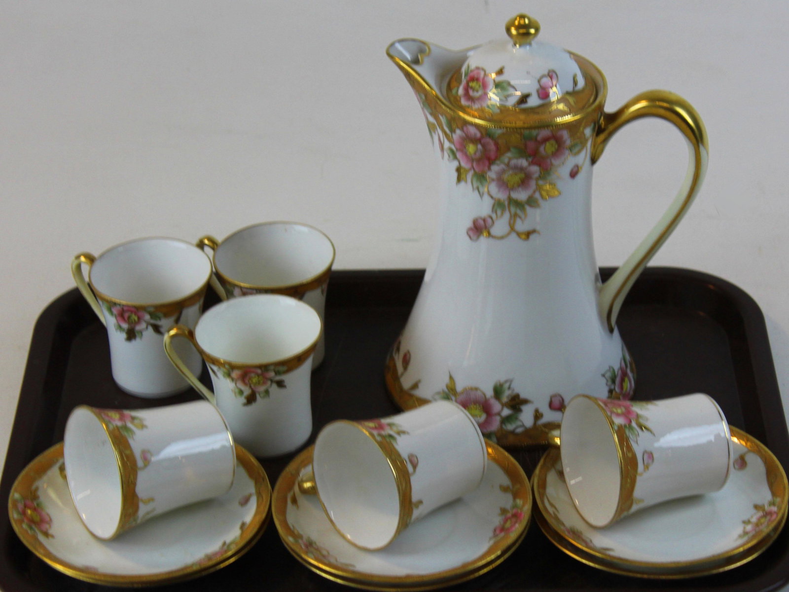 Nippon gilt enamel floral edge chocolate set: ca 1900 Nippon Art Nouveau style chocolate set with gilt raised enamel edge having floral border, consisting of cocoa pot and 6 demitasse cups and saucers
