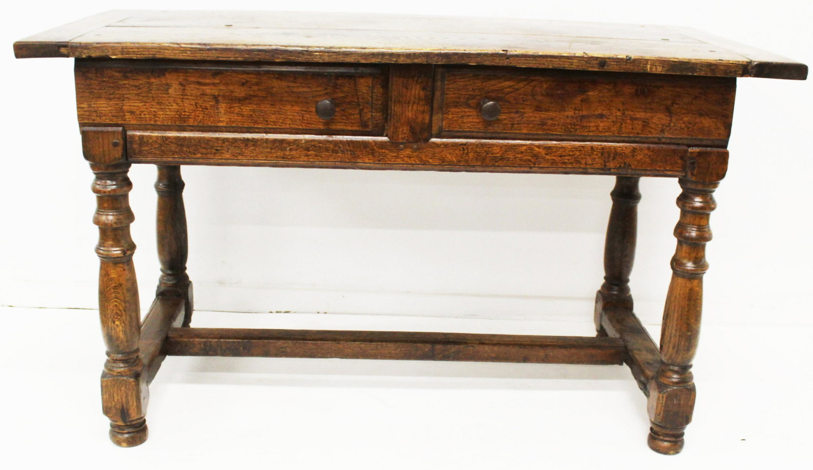 Jacobean revival work table: 20th hand made Jacobean revival oak & chestnut two drawer work table. Stretcher base, bread board top, worn surface. Two slide front drawers. 52" l, 24" wide, 30" high.