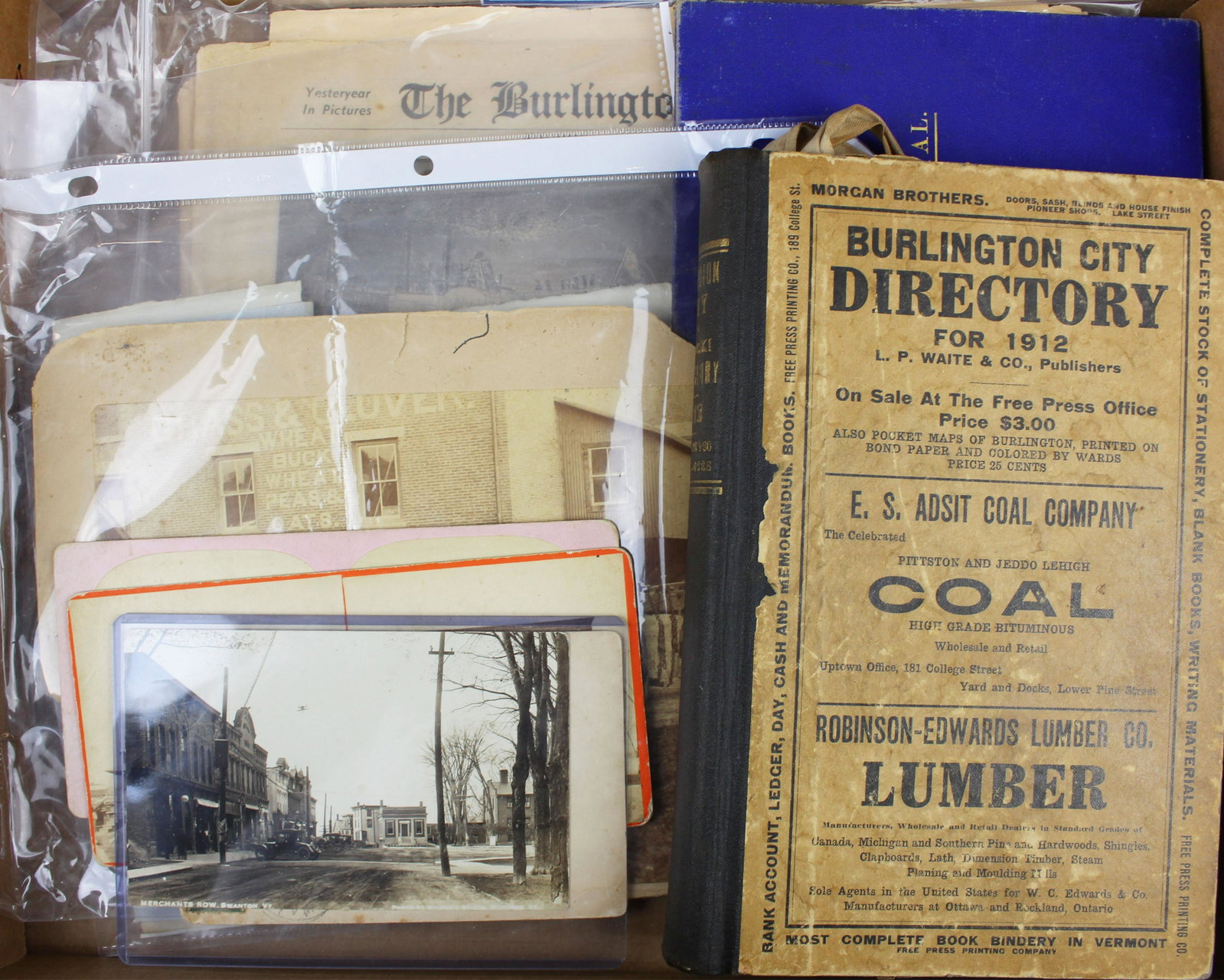 Swanton, VT photos, Burlington Directory, etc.: lot of Northern Vermont ephemera including Swanton, VT livery photo, two Swanton stereoviews by Truax, RPPC of downtown Swanton, 1840's Burlington Post Office receipts, 1912 Burlington City Directory,
