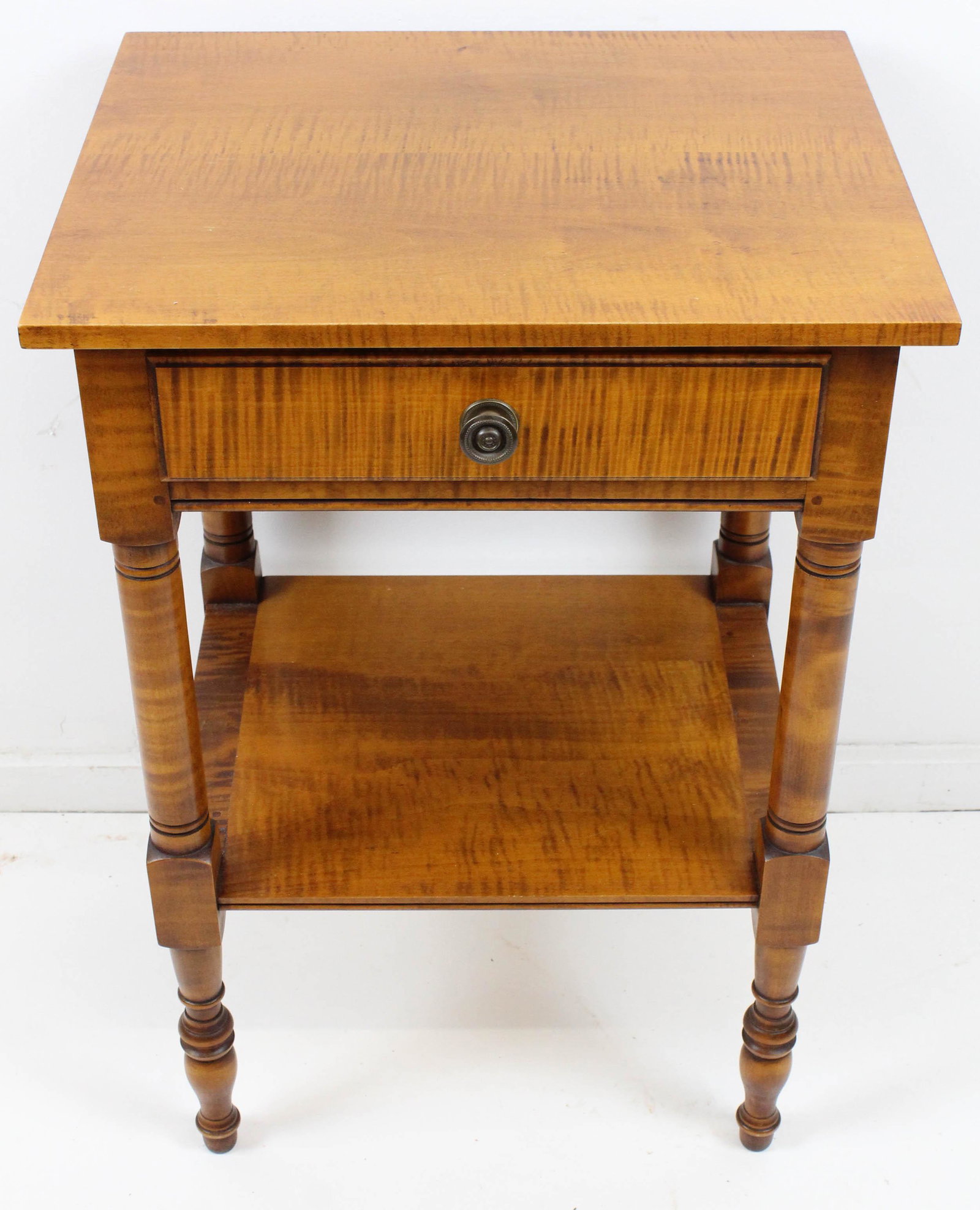 Eldred Wheeler tiger maple one drawer stand: Fine late 20th c. labeled Eldred Wheeler highly figured tiger maple Sheraton style one drawer stand with lower bread board ended shelf and turned legs 29" x 20" x 17"