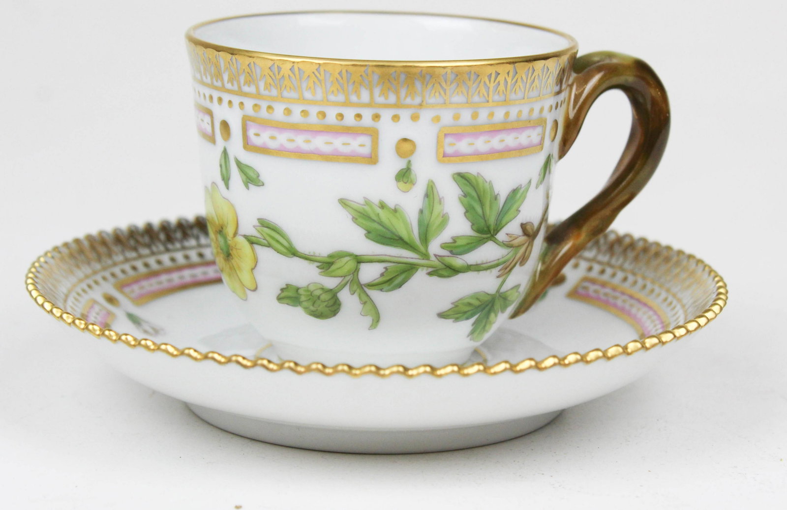 Royal Copenhagen Flora Danica demitasse cup: Royal Copenhagen Flora Danica pattern porcelain demitasse cup and saucer with buttercup botanical decoration and gilt crenellated rim, accompanied by 1950 leather bound monograph in slip case describi