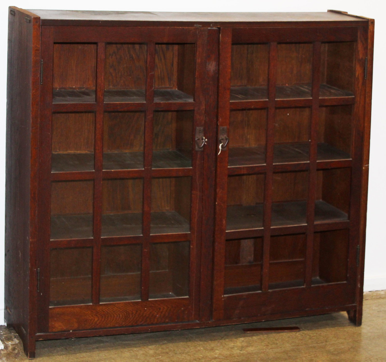 Gustav Stickley Mission Oak 2 Door Bookcase: ca. 1914 Gustav Stickley mission oak bookcase having two doors with 12 panes, in original finish retaining paper Craftsman label 53" x 60" x 13' -as found, backsplash removed, 2 panes missing, imperfe