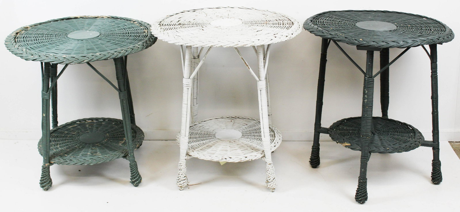 3 1920's Wicker Round End Tables: 3 1920's wicker round end tables, each having lower shelf in old green and white paint, one retaining brass label from Paine Furniture Co. Boston approx. 29" x 27"