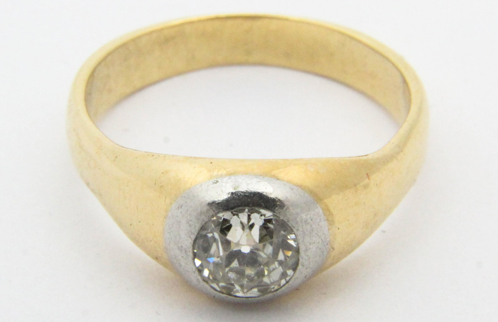 Men's diamond .8 ct round cut solitaire ring: Men's diamond ring set with a round cut .8 ct diamond VS2 L color. Set in a platinum bezel and 14k yellow gold band. Ring size 10.