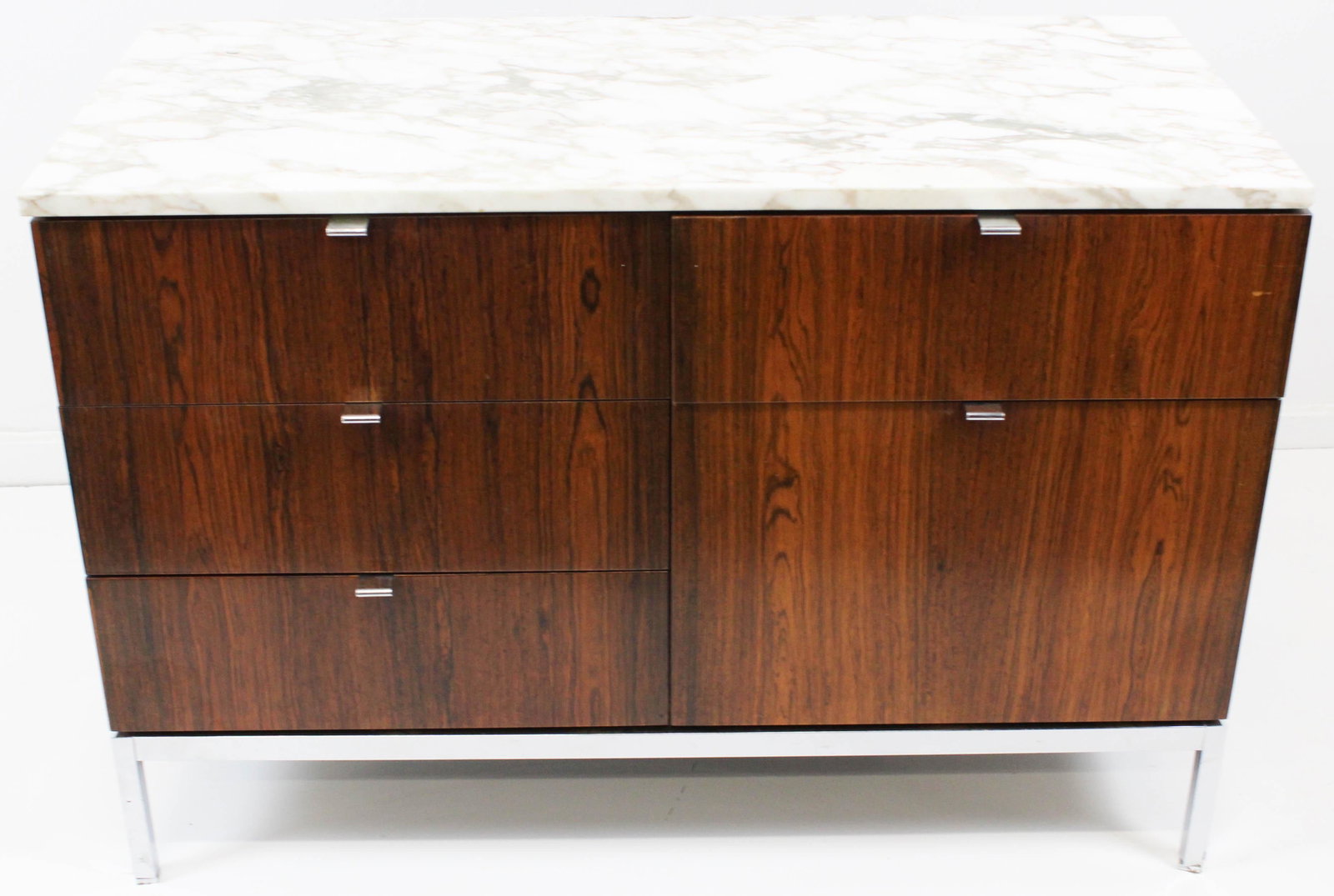 Florence Knoll rosewood cabinet: A Florence Knoll rosewood & Carrera marble top cabinet. Cabinet can lock from the top and has five drawers and sits on chromed steel legs. Mid 20th century. 26" x 37 1/2" x 18" "Lock on Top Cabinet". 