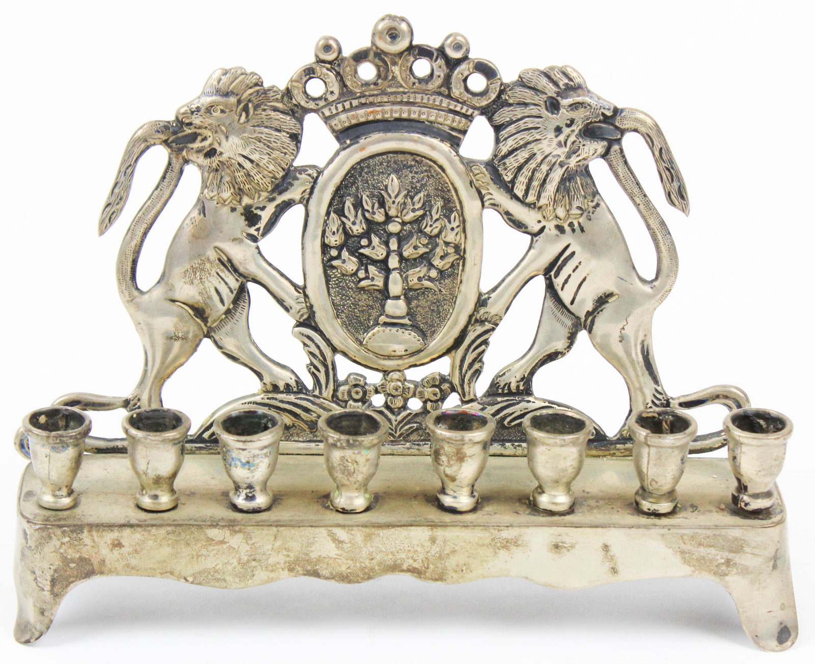 Mexican Sterling Silver Menorah by Conquistador: Finely detailed Mexican sterling silver Menorah by Conquistador having 8 threaded removeable candleholders on raised platform base with hand chased repousse Judaica back featuring two lions flanking c