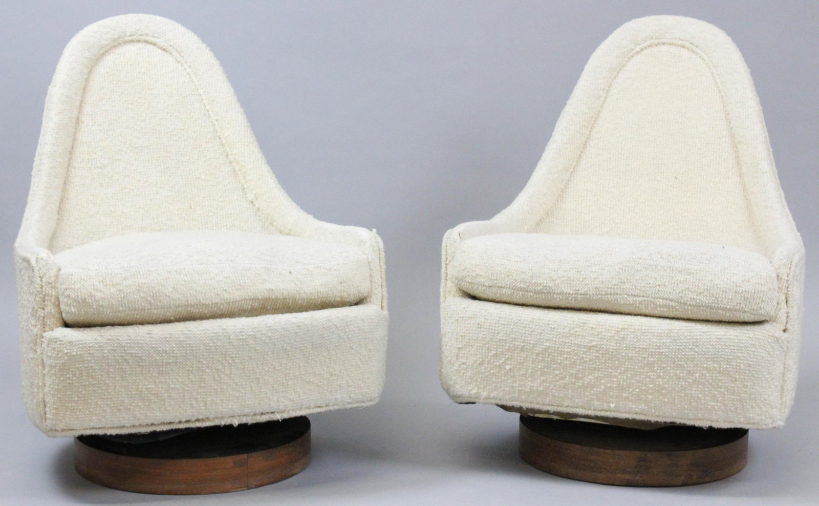 Pair of Milo Baughman swivel chairs: A pair of Milo Baughman swivel chairs. Model 3400. Original receipt and original tags on chairs. Cream fabric covering