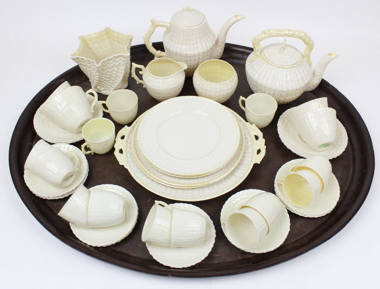 45 pc. Belleek Irish Bone China Porcelain Tea Set: 45 pc. Belleek Irish bone china porcelain assembled shell form tea set including two tea pots, sugar and creamer, cake plate, 13 demitasse cups, luncheon plates, -vase has a chip to rim