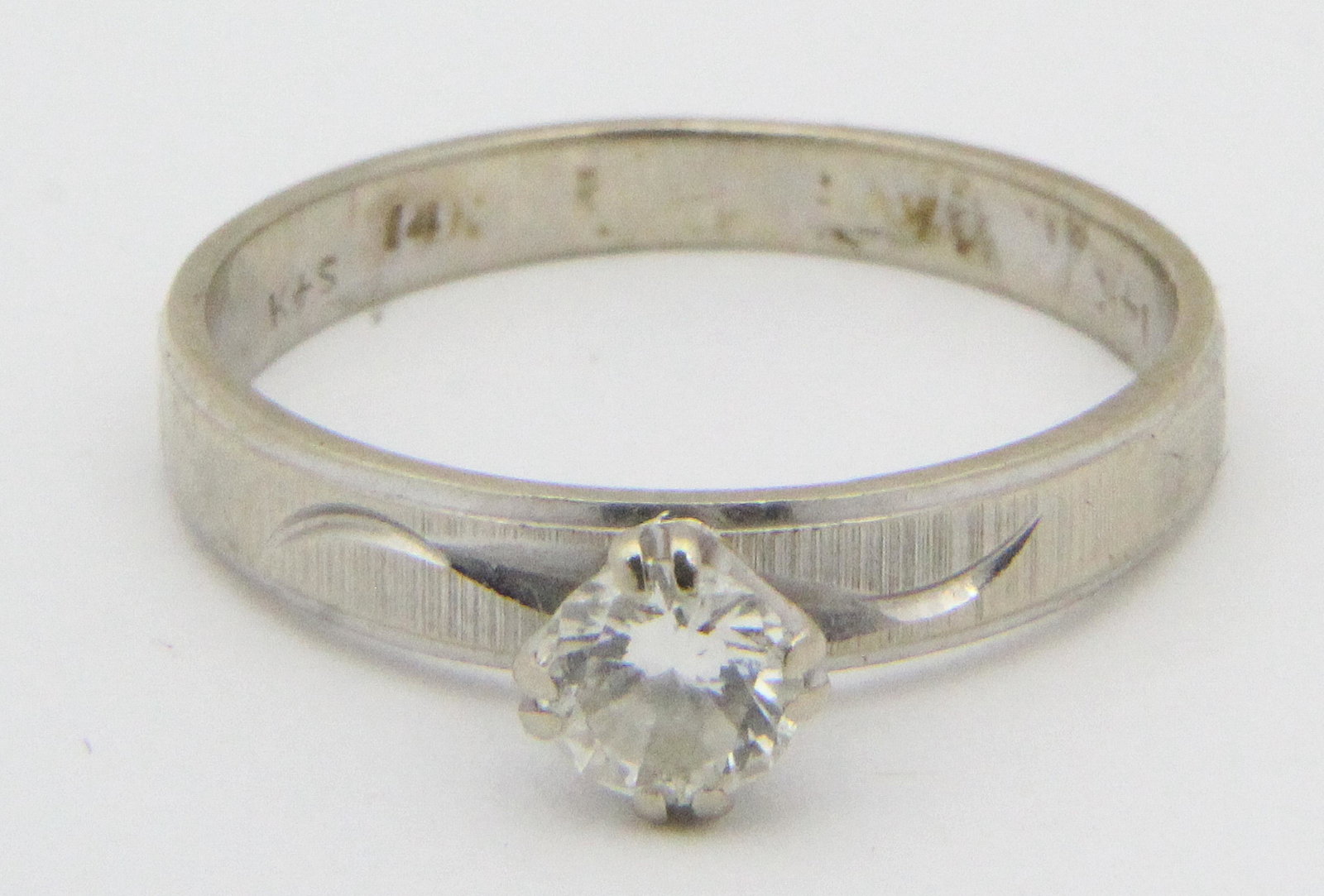 Diamond & 14k white gold engagement ring: Diamond round cut engagement ring with a 1/4 ct solitaire diamond set in 14k white gold ring size 6.