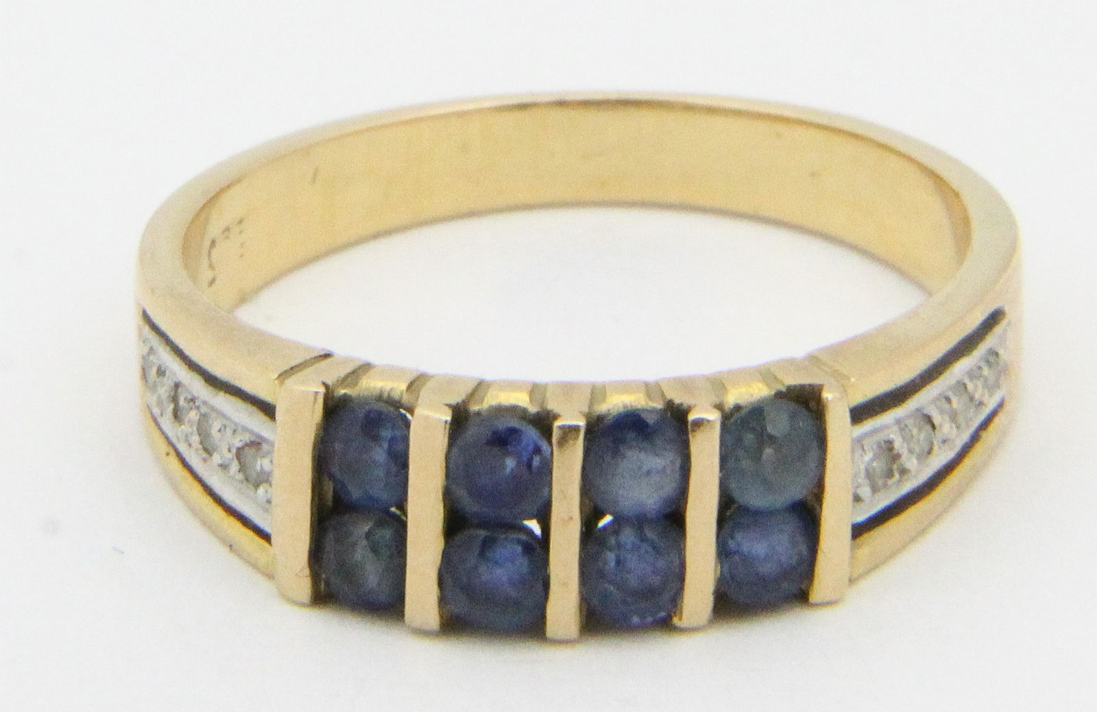 Sapphire, diamond, & 14k yellow gold band.: A sapphire, diamond, & 14k yellow gold ring with 4 rows of 2 round cut sapphires each .05 cts or .8 cts t.w. sapphires with 2 rows of 4 .01 ct diamonds. Ring size 6.