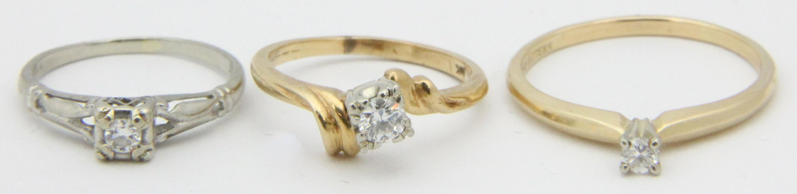 A group of 3 14k diamond rings: A group of 3 solitaire round cut diamond rings. Each set in 14k gold. .1 to .15 ct diamonds.